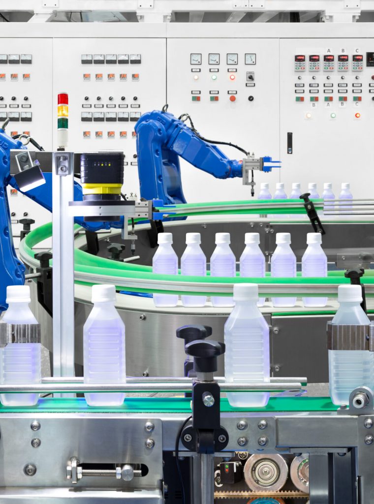 Robotic arm holding water bottles on production line in factory, Industry 4.0 concept